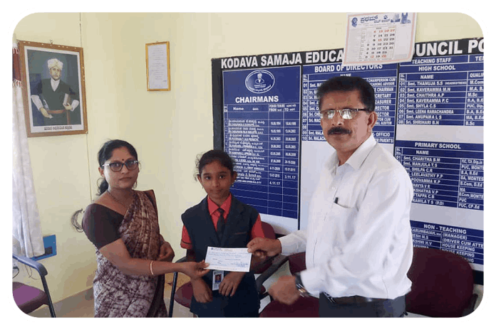 Handing over assistance cheque to beneficiary by Secretary of KESST.