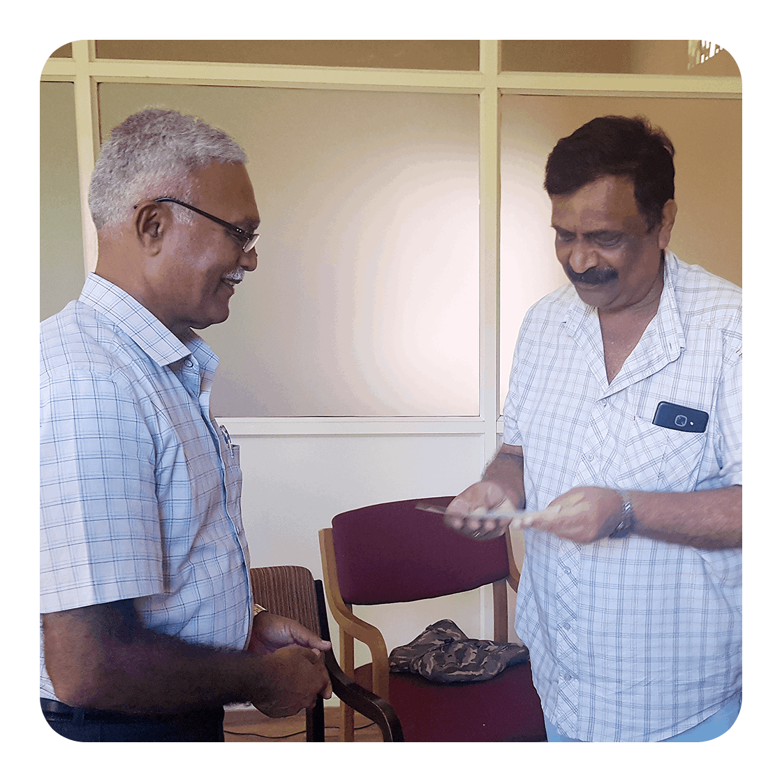 KESST  |  Recent Activities - Shri Mandapanda Sada Chengappa, President KESST, handing over a cheque to Sai Shankar School Ponnnampet (to Shri Kolera Zaroo Ganapathy) for financial assistance for the education of flood-affected children.